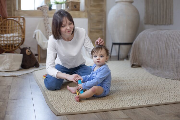 Baby Yoga: The Benefits and How to Get Started 66 Optimized full shot smiley mother with baby home