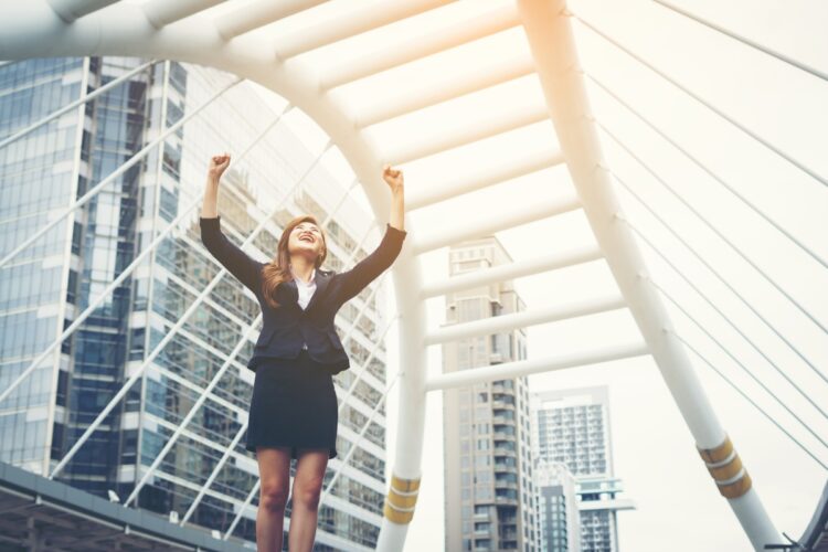 Beyond the Physique: The Transformative Impact of Calisthenics on Mental Health and Well-Being 53 Optimized happy success businesswoman overlooking into city center hands raised