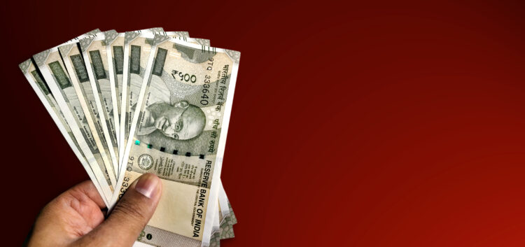 Decoding the Future: Will India Witness Further Demonetization Efforts? 51 hand holding five hundred indian rupee notes against white background