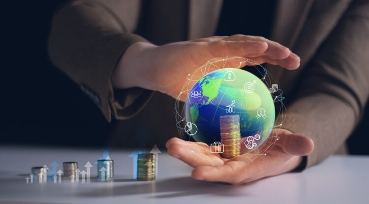 person holding globe with word money it