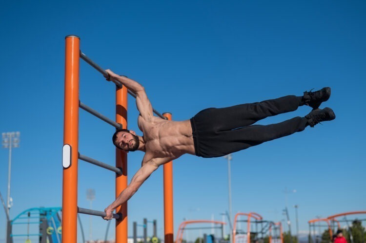 Ascend to Power: Mastering the Art of Upper Body Strength with Calisthenics 53 shirtless man doing human flag outdoors