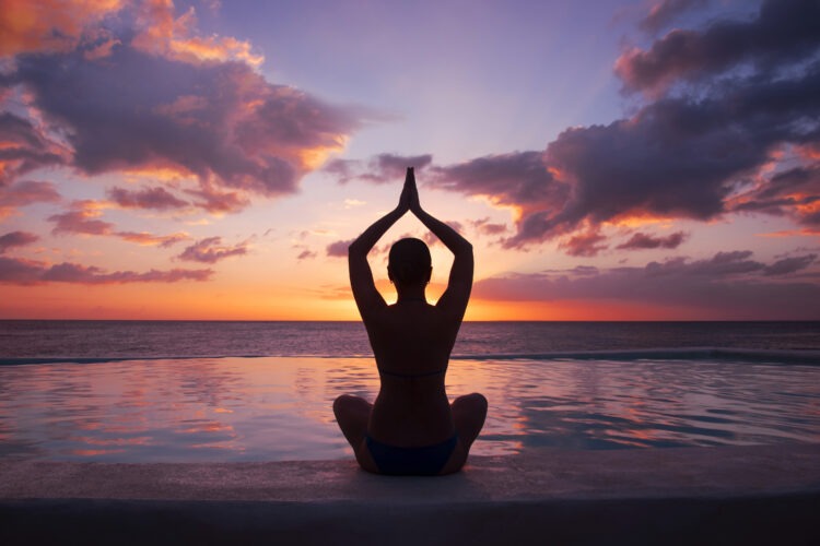 Beyond the Physique: The Transformative Impact of Calisthenics on Mental Health and Well-Being 52 woman doing yoga against setting sun